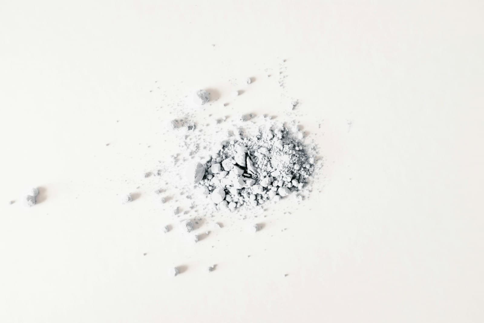 A small pile of fine peptide powder on a cream studio surface — representative of how Pepoderma ships AHK-Cu (Copper Tripeptide-3) as a bulk lyophilised active for scalp serum and hair-regrowth formulations.