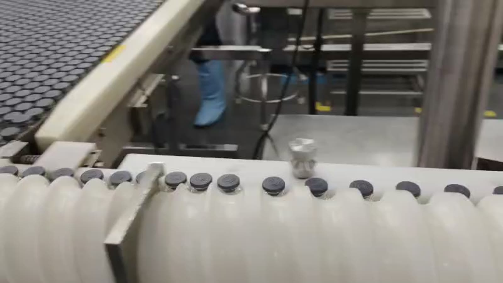Sterile peptide vials moving through Pepoderma's ISO 7/8 cleanroom filling line, the production capacity behind custom-synthesis and OEM private-label work.